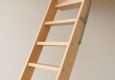 Close-up of a wooden loft ladder showcasing natural wood grain and design
